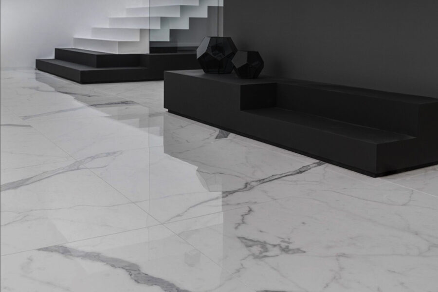 Habitación con suelo de gres porcelánico pulido con efecto mármol, mobiliario blanco y negro.